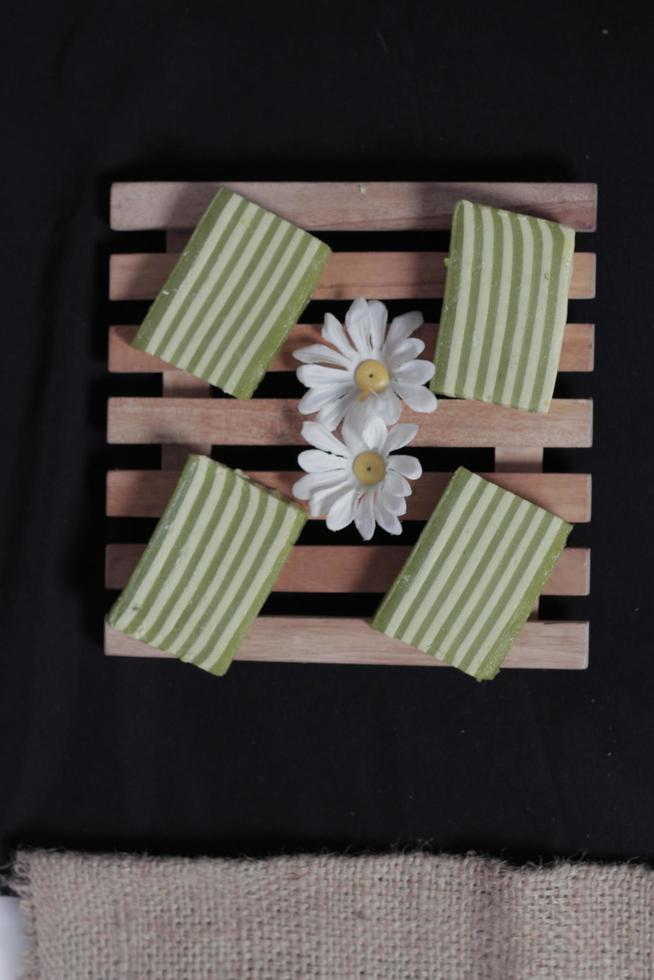 Original and pandan flavored layer cake. Layer cake is ready to accompany your morning with a glass of tea. Indonesian cake. We often see it as a side dish during Eid. Sweet and soft cake. Focus blur. photo