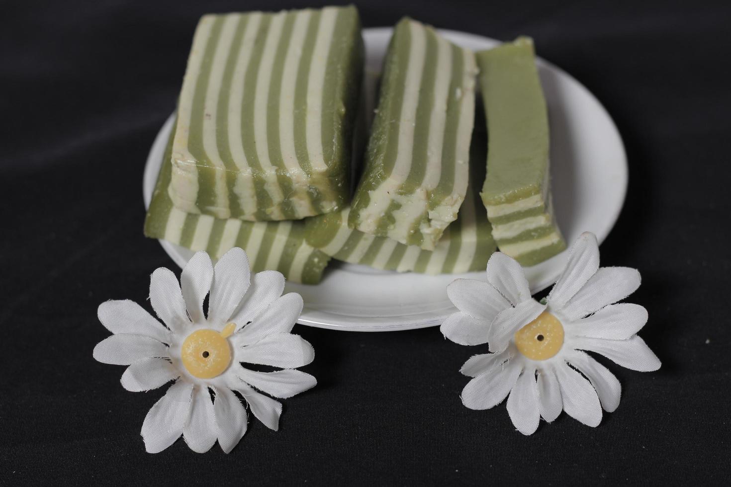 Original and pandan flavored layer cake. Layer cake is ready to accompany your morning with a glass of tea. Indonesian cake. We often see it as a side dish during Eid. Sweet and soft cake. Focus blur. photo