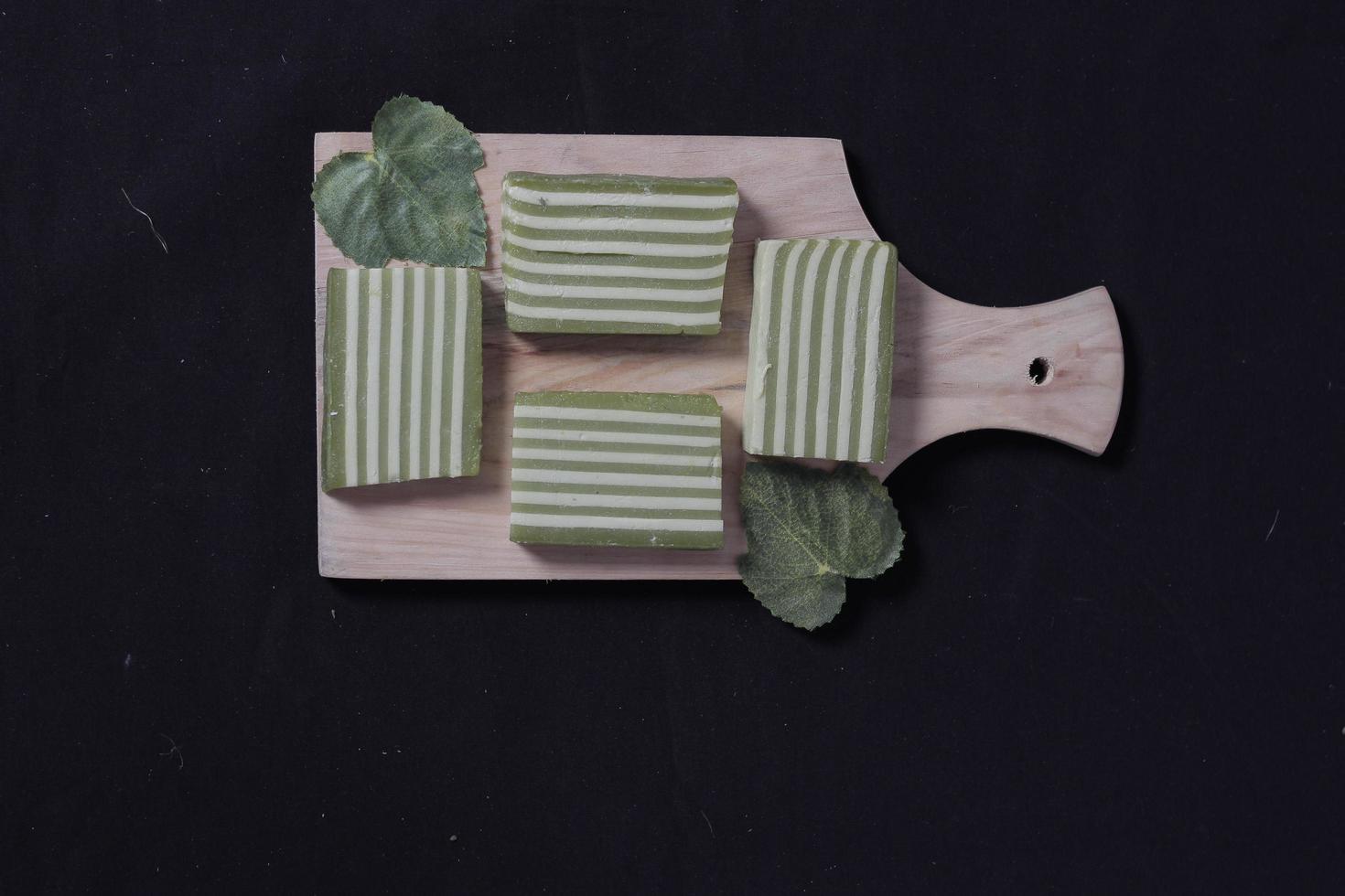 Original and pandan flavored layer cake. Layer cake is ready to accompany your morning with a glass of tea. Indonesian cake. We often see it as a side dish during Eid. Sweet and soft cake. Focus blur. photo