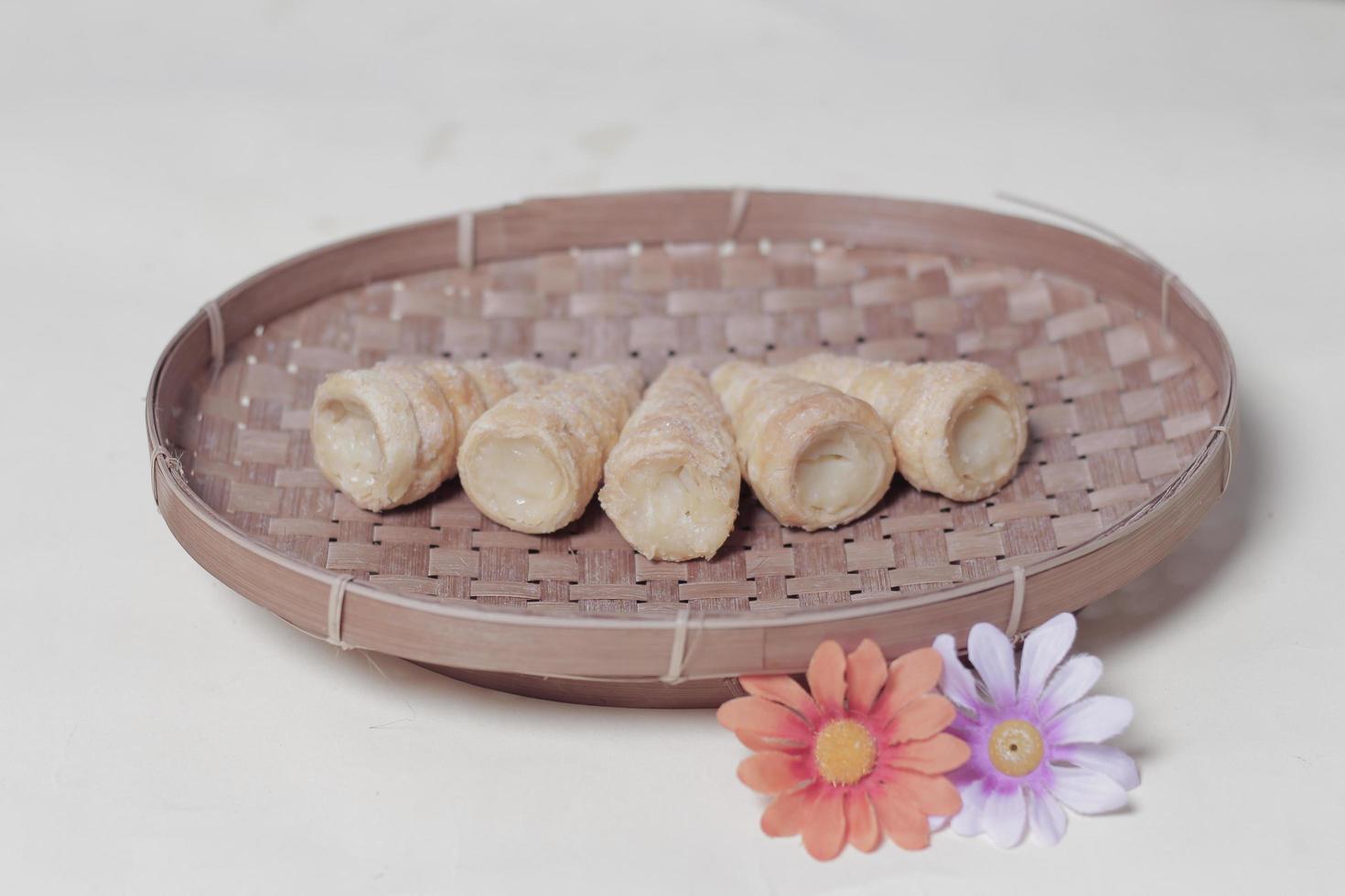 In Indonesia, this cake is known as cumcum cake. A cake shaped like a trumpet, or an ice cream cone. The perfect combination of a dry cake studded with sugar, plus a delicious cream vanilla filling. photo