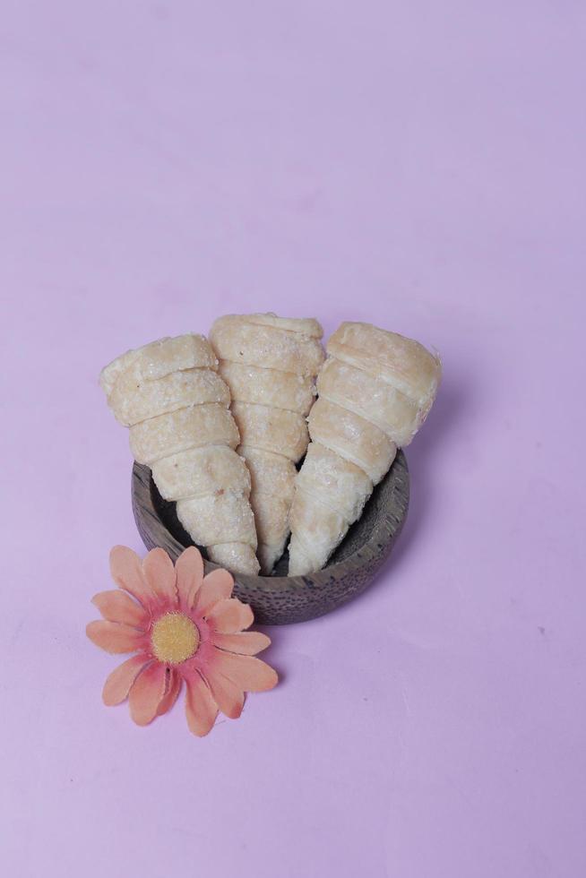 In Indonesia, this cake is known as cumcum cake. A cake shaped like a trumpet, or an ice cream cone. The perfect combination of a dry cake studded with sugar, plus a delicious cream vanilla filling. photo