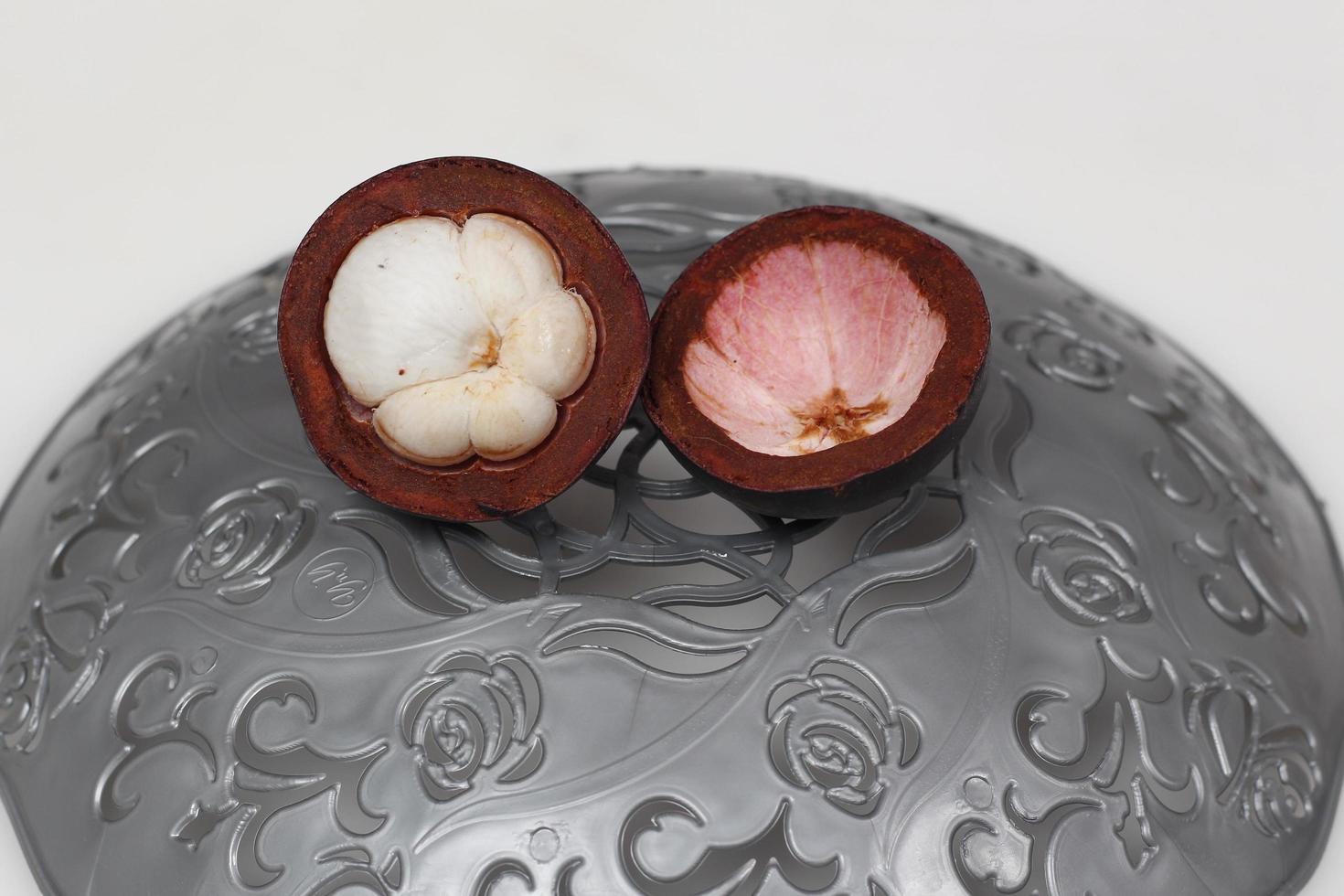 Mangosteen is a tropical fruit from Asia. Mangosteen has a distinctive sweet and sour taste. Mangosteen also has a myriad of benefits, properties, and nutritional content that is useful for health. photo
