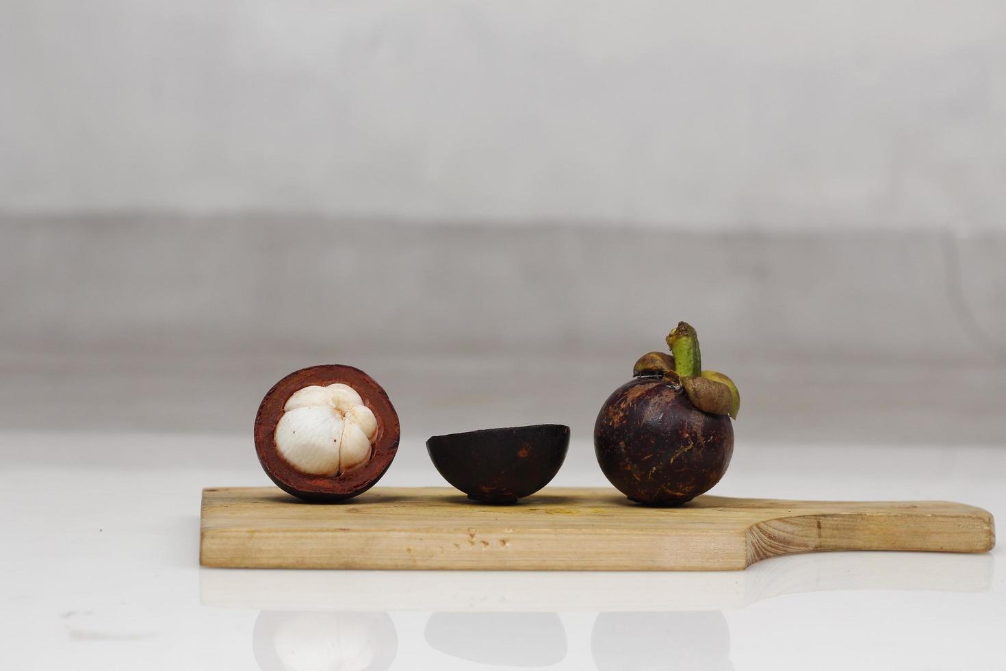 Mangosteen is a tropical fruit from Asia. Mangosteen has a distinctive sweet and sour taste. Mangosteen also has a myriad of benefits, properties, and nutritional content that is useful for health. photo