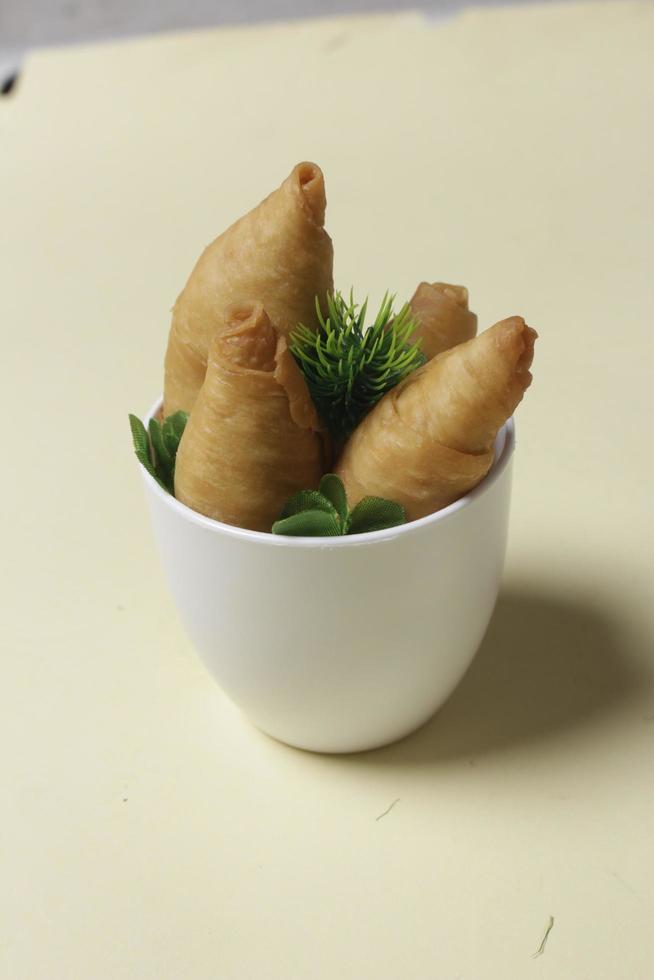 Savory molen banana cake for snacks to accompany the breakfast menu. Molen bananas with pastries are usually served with a cup of hot coffee or tea. Market snacks. Focus blur. Focus on some angels. photo
