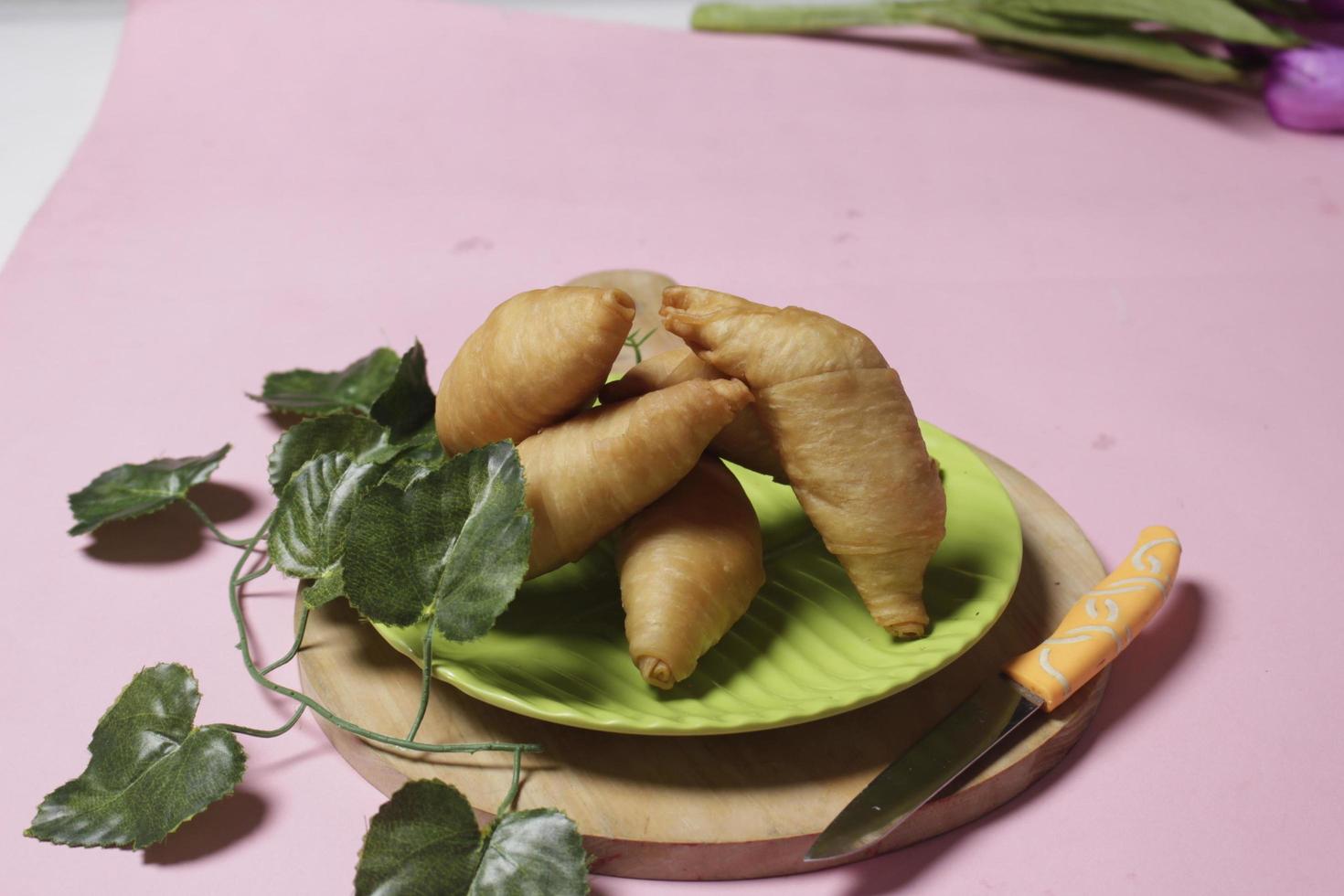 Chocolate bananas from raw materials covered with rolls of pastry dough sheets. Molen bananas with pastries are usually served with a cup of hot coffee or tea. Focus blur photo