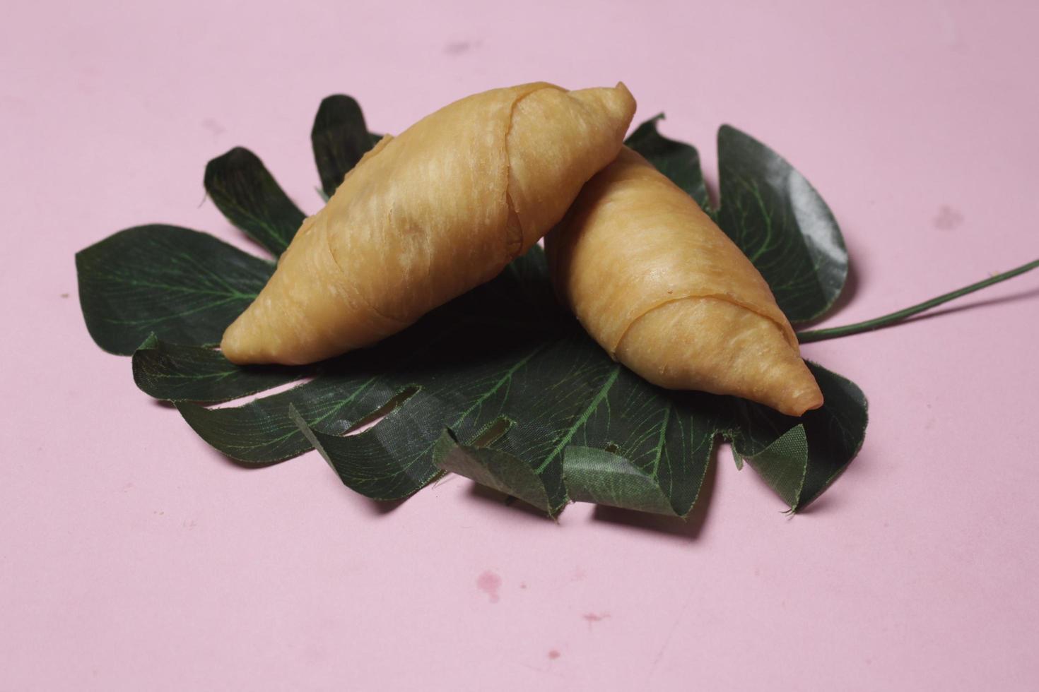 Chocolate bananas from raw materials covered with rolls of pastry dough sheets. Molen bananas with pastries are usually served with a cup of hot coffee or tea. Focus blur photo