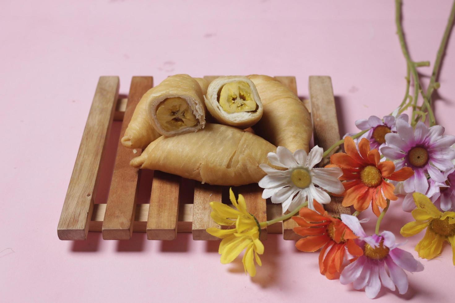 Chocolate bananas from raw materials covered with rolls of pastry dough sheets. Molen bananas with pastries are usually served with a cup of hot coffee or tea. Focus blur photo