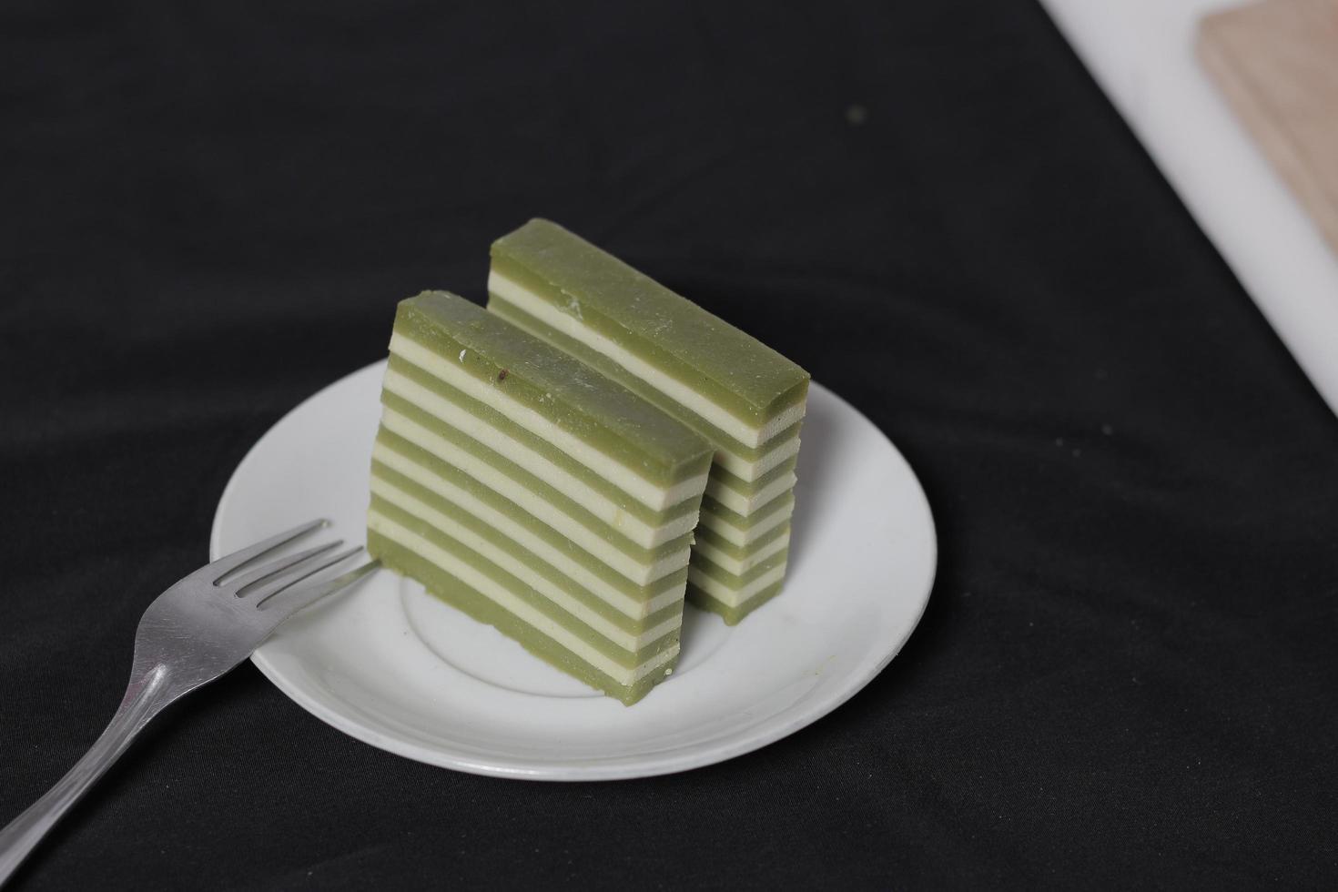 Original and pandan flavored layer cake. Layer cake is ready to accompany your morning with a glass of tea. Indonesian cake. We often see it as a side dish during Eid. Sweet and soft cake. Focus blur. photo