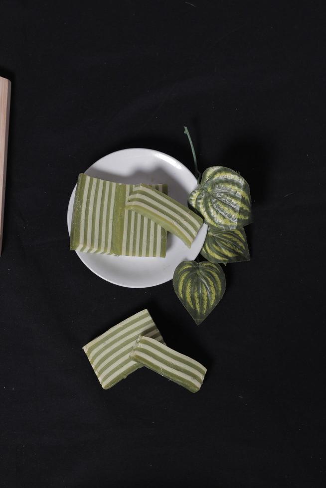 Original and pandan flavored layer cake. Layer cake is ready to accompany your morning with a glass of tea. Indonesian cake. We often see it as a side dish during Eid. Sweet and soft cake. Focus blur. photo