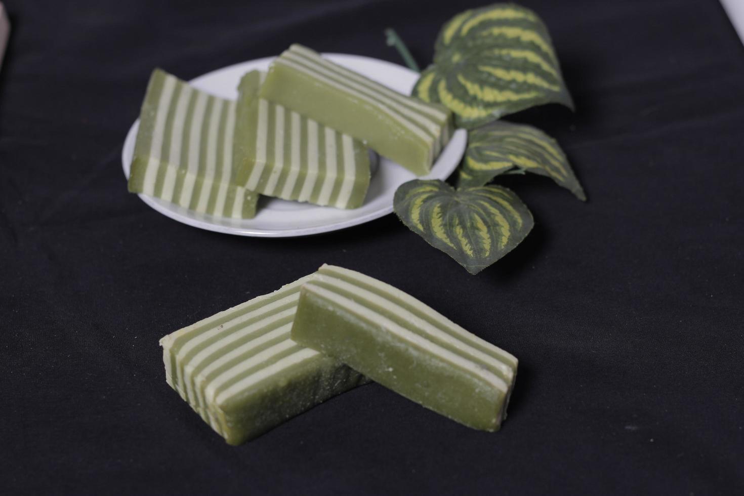 Original and pandan flavored layer cake. Layer cake is ready to accompany your morning with a glass of tea. Indonesian cake. We often see it as a side dish during Eid. Sweet and soft cake. Focus blur. photo