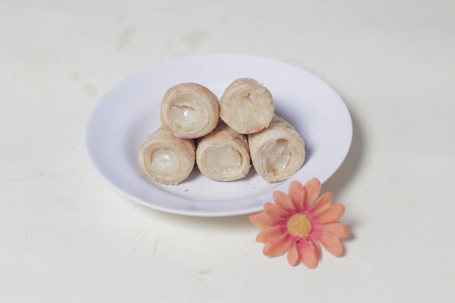 In Indonesia, this cake is known as cumcum cake. A cake shaped like a trumpet, or an ice cream cone. The perfect combination of a dry cake studded with sugar, plus a delicious cream vanilla filling. photo