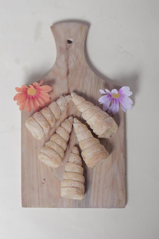 In Indonesia, this cake is known as cumcum cake. A cake shaped like a trumpet, or an ice cream cone. The perfect combination of a dry cake studded with sugar, plus a delicious cream vanilla filling. photo