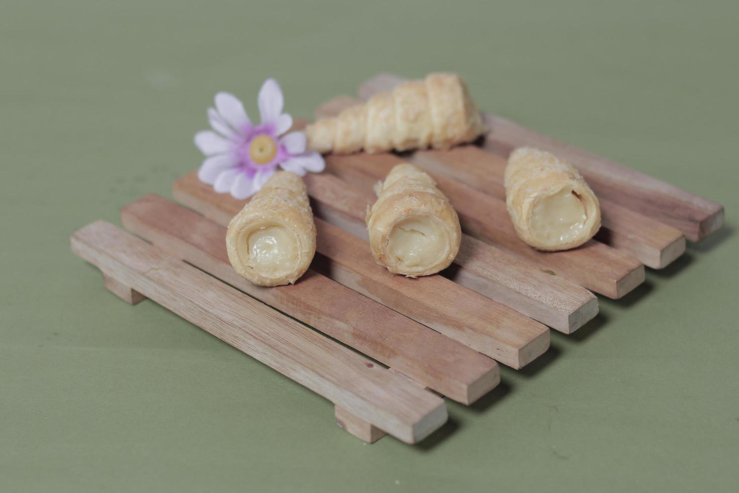 In Indonesia, this cake is known as cumcum cake. A cake shaped like a trumpet, or an ice cream cone. The perfect combination of a dry cake studded with sugar, plus a delicious cream vanilla filling. photo