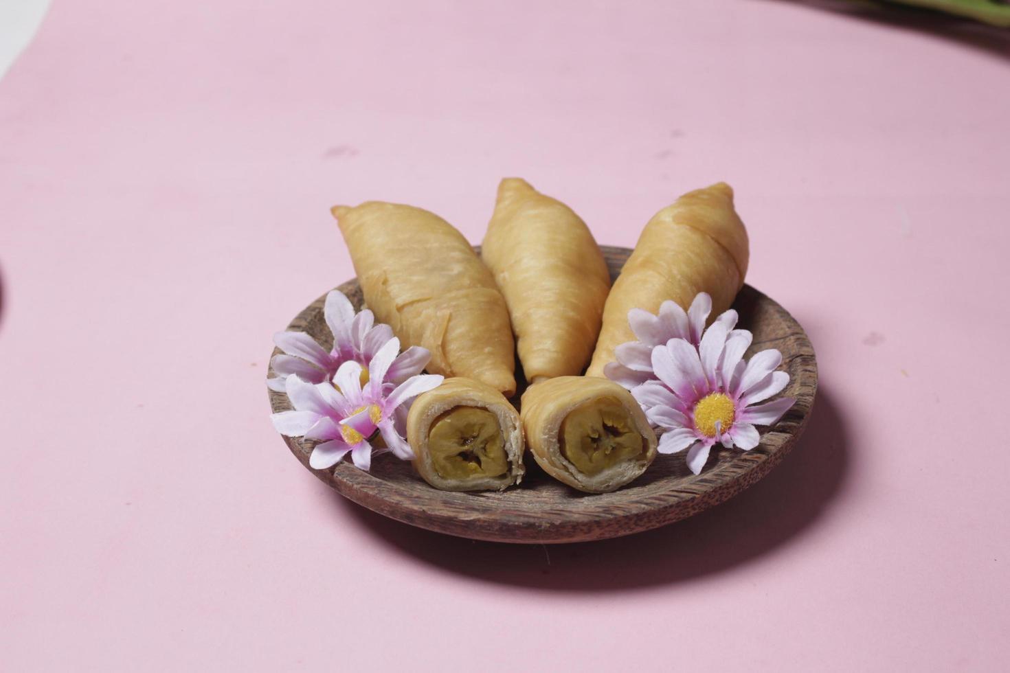 Chocolate bananas from raw materials covered with rolls of pastry dough sheets. Molen bananas with pastries are usually served with a cup of hot coffee or tea. Focus blur photo