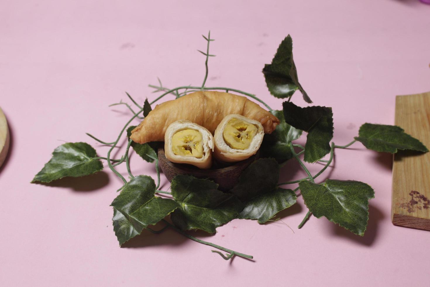 Chocolate bananas from raw materials covered with rolls of pastry dough sheets. Molen bananas with pastries are usually served with a cup of hot coffee or tea. Focus blur photo