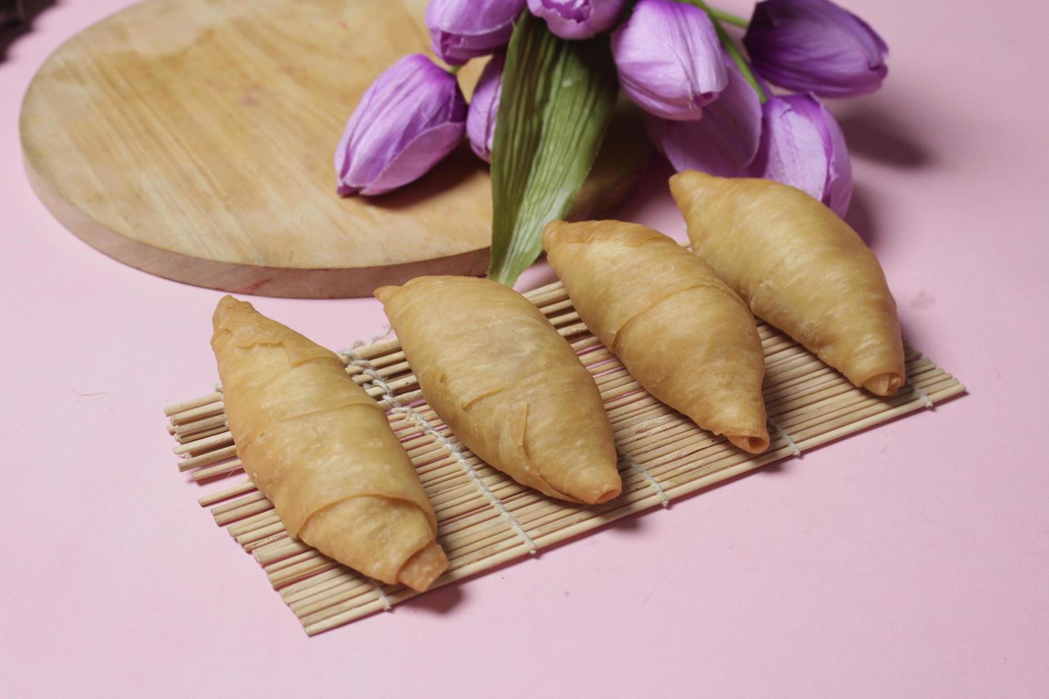 Chocolate bananas from raw materials covered with rolls of pastry dough sheets. Molen bananas with pastries are usually served with a cup of hot coffee or tea. Focus blur photo