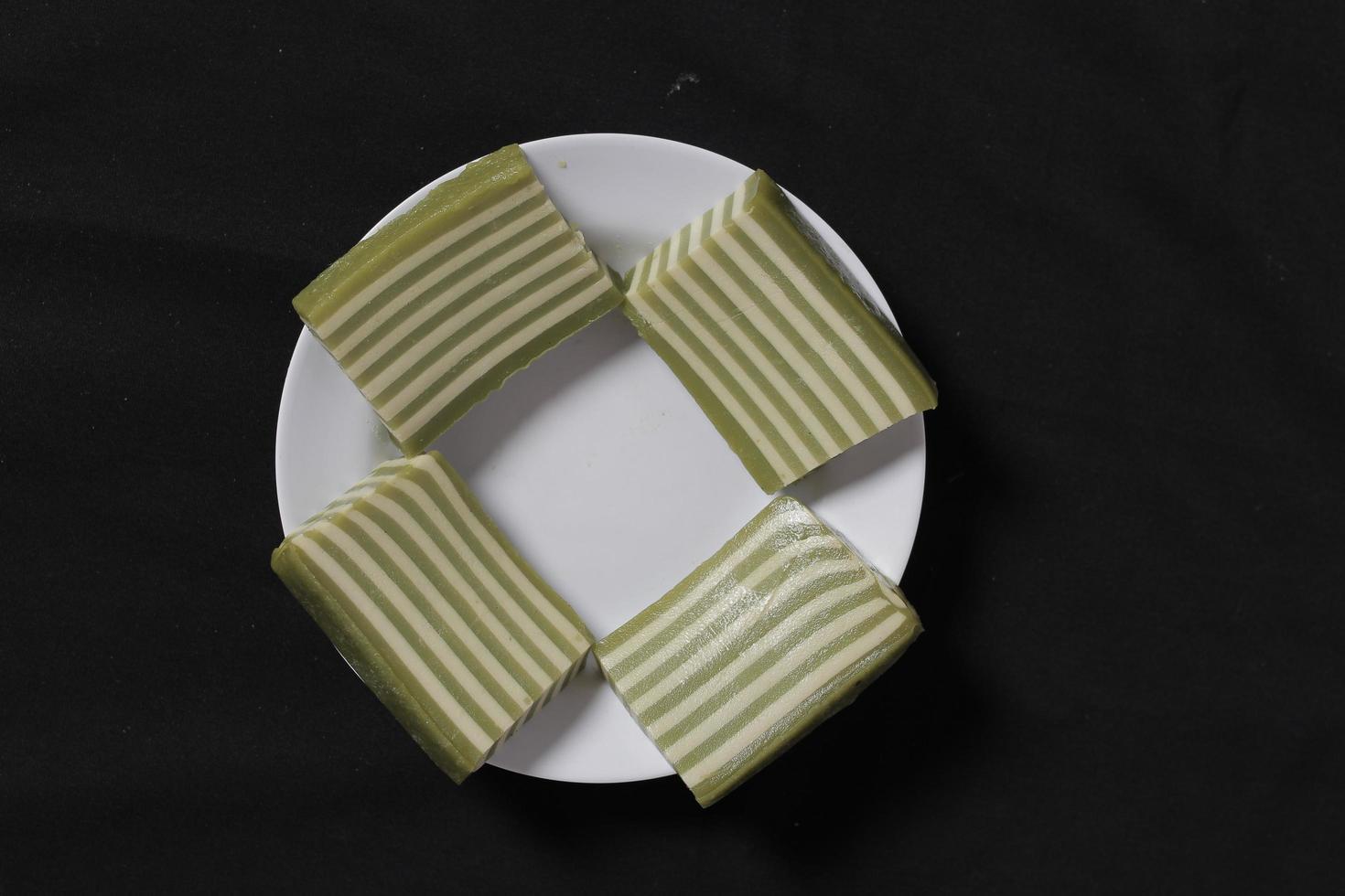 Original and pandan flavored layer cake. Layer cake is ready to accompany your morning with a glass of tea. Indonesian cake. We often see it as a side dish during Eid. Sweet and soft cake. Focus blur. photo