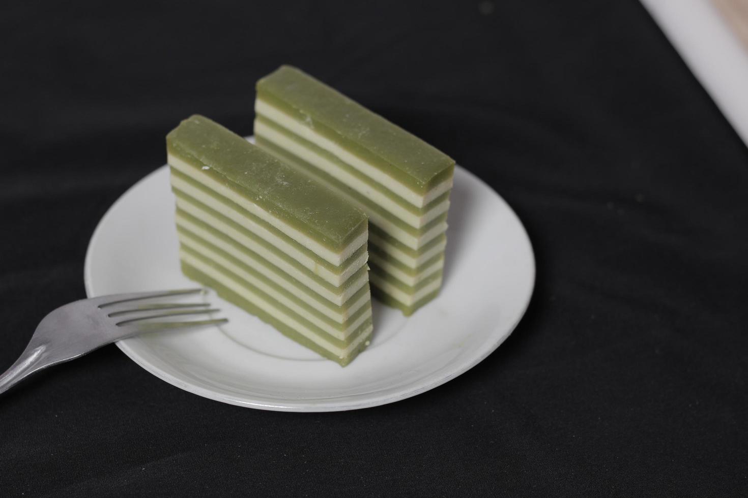 Original and pandan flavored layer cake. Layer cake is ready to accompany your morning with a glass of tea. Indonesian cake. We often see it as a side dish during Eid. Sweet and soft cake. Focus blur. photo