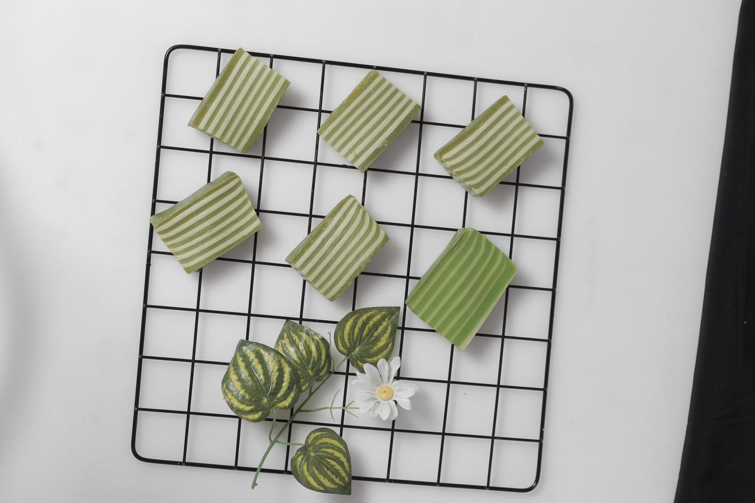 Original and pandan flavored layer cake. Layer cake is ready to accompany your morning with a glass of tea. Indonesian cake. We often see it as a side dish during Eid. Sweet and soft cake. Focus blur. photo