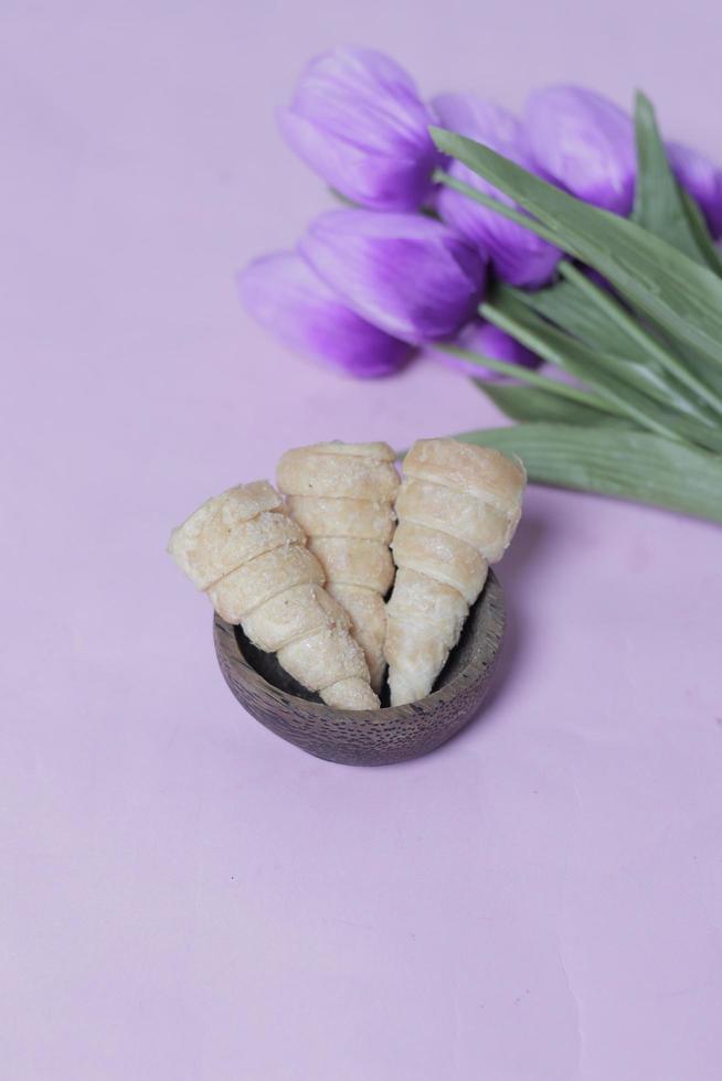 In Indonesia, this cake is known as cumcum cake. A cake shaped like a trumpet, or an ice cream cone. The perfect combination of a dry cake studded with sugar, plus a delicious cream vanilla filling. photo