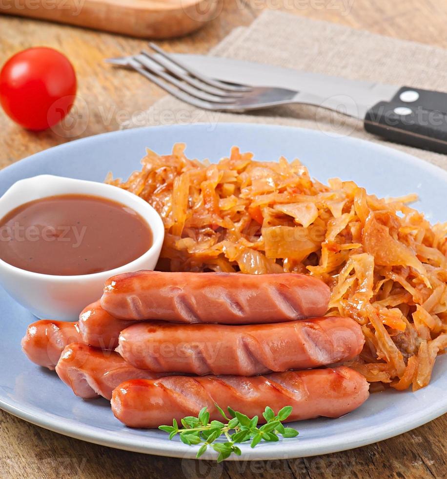Sausages and fried cabbage photo