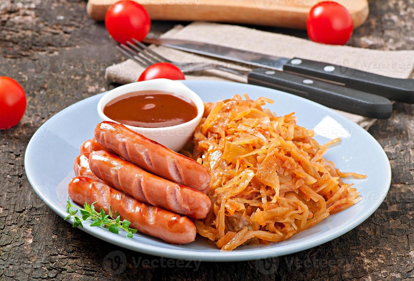 Sausages and fried cabbage photo