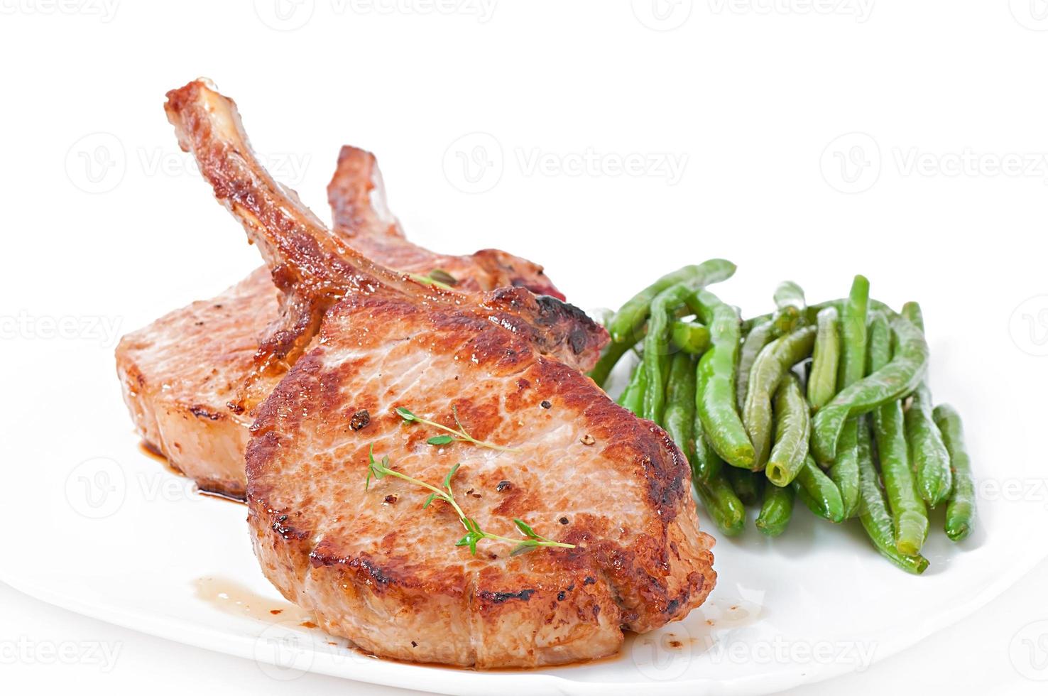 Juicy grilled pork fillet steak with  green beans photo