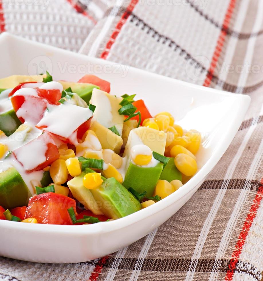 Mixed salad with avocado, tomatoes and sweet corn photo