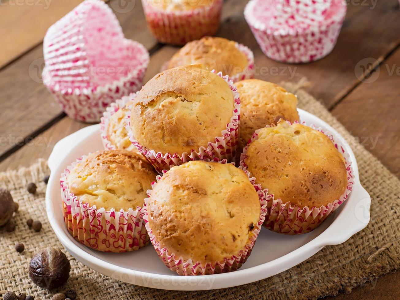 Fruit muffins with nutmeg and allspice on a wooden background photo