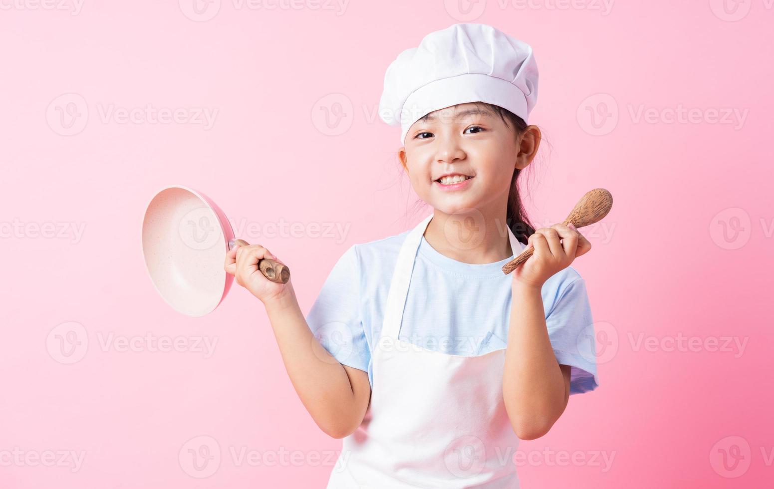 Image of Asian child practicing to be a chef photo