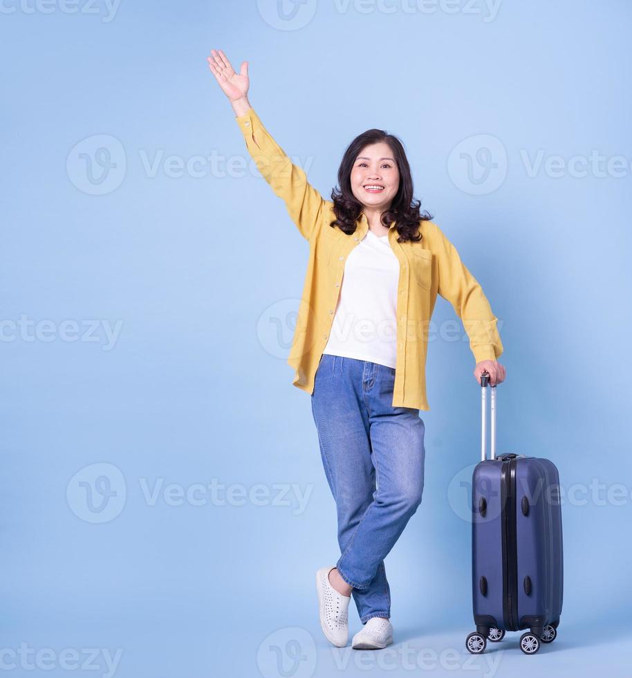 Full length image of middle aged Asian woman on background, summer concept photo