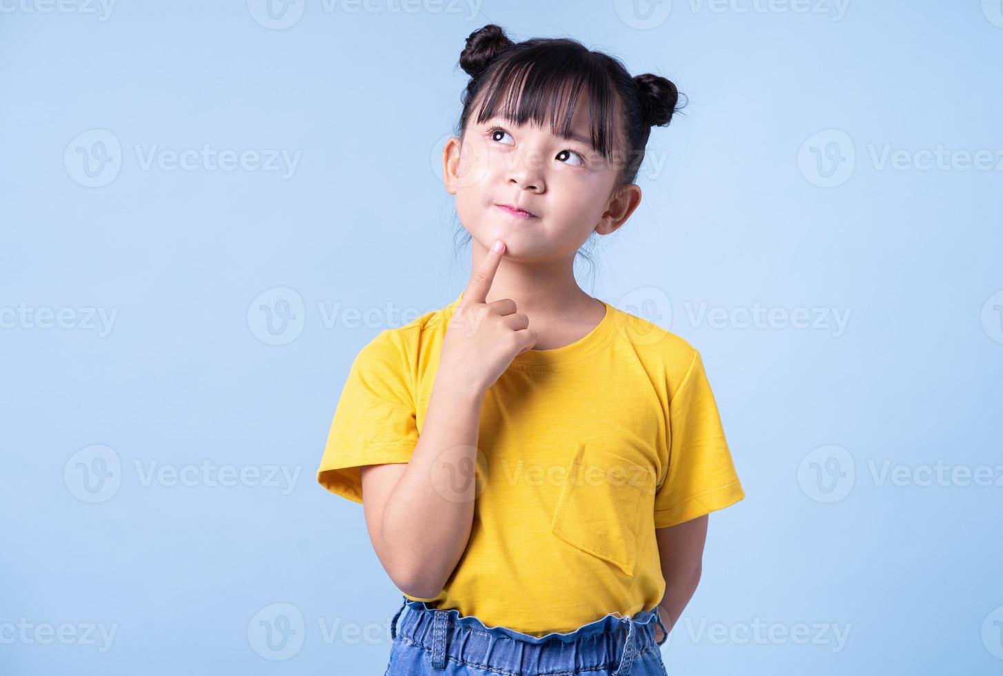 Image of Asian child posing on blue background photo