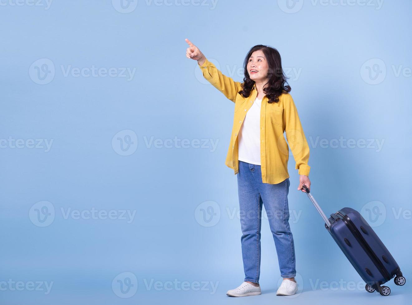 Full length image of middle aged Asian woman on background, summer concept photo