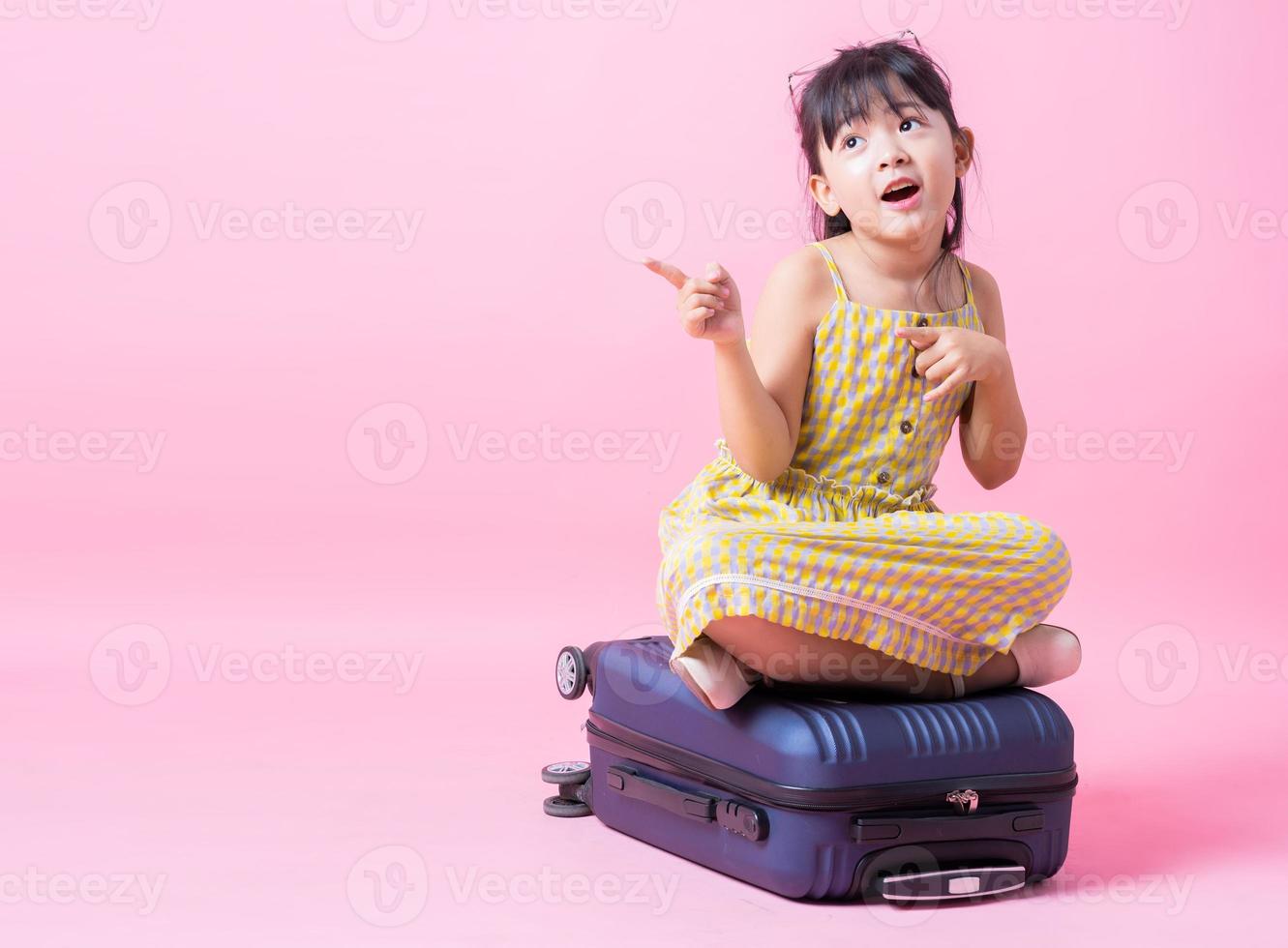 Image of Asian child with suitcase, summer concept photo