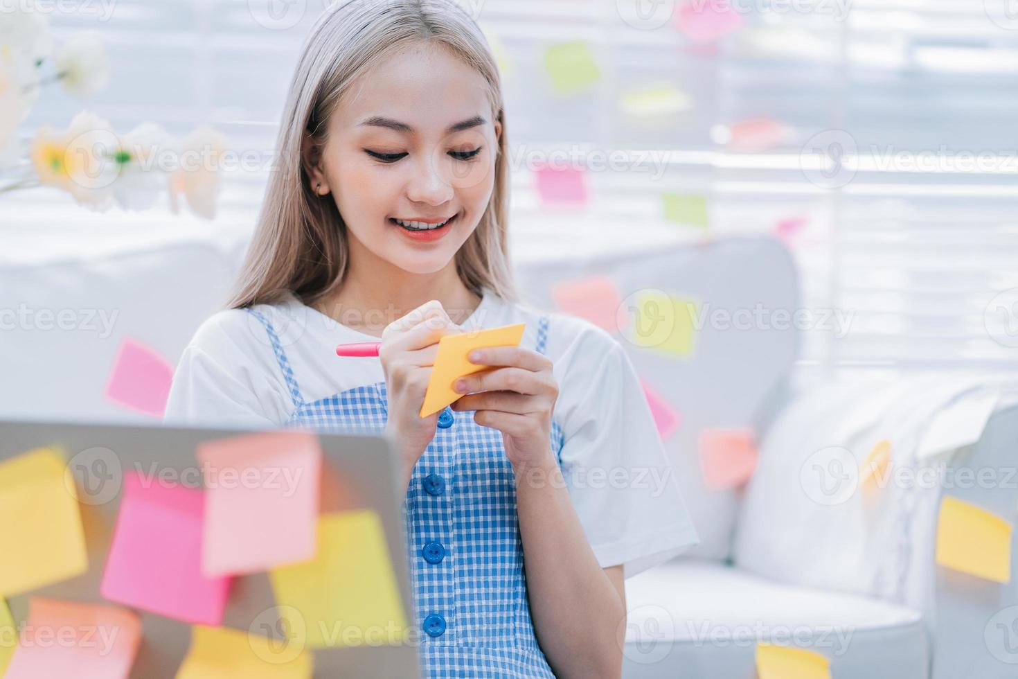 Young Asian girl using laptop at home photo