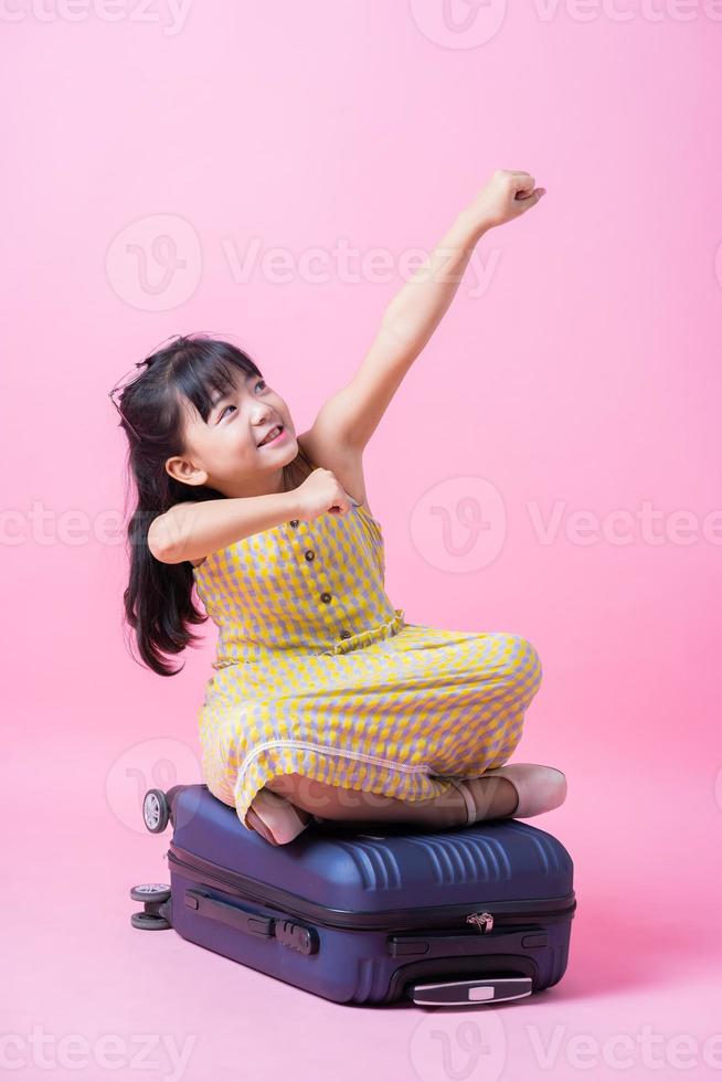 Image of Asian child with suitcase, summer concept photo