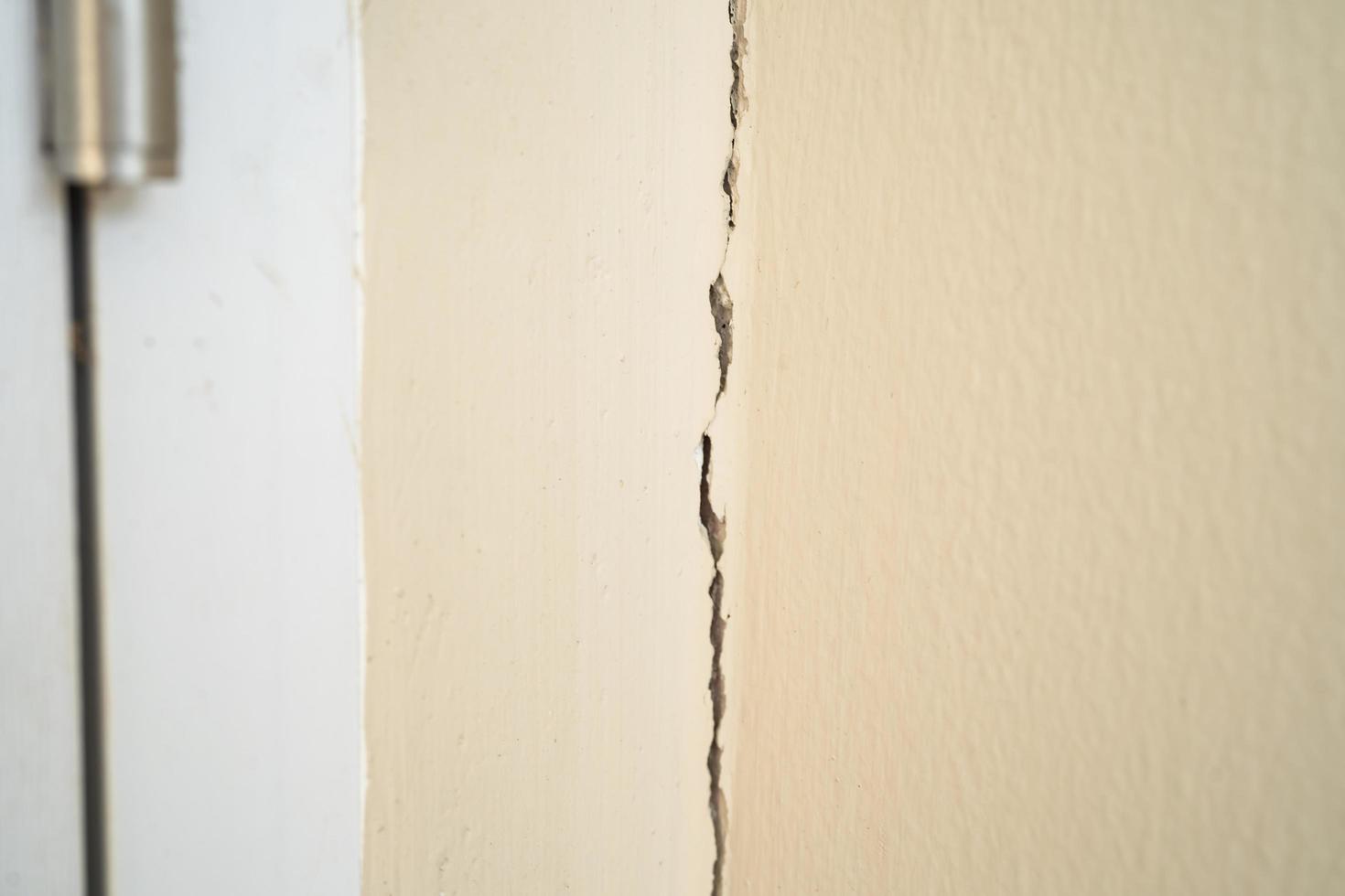 Settlement cracks of cement wall that occur at expansion joints in house structure. photo