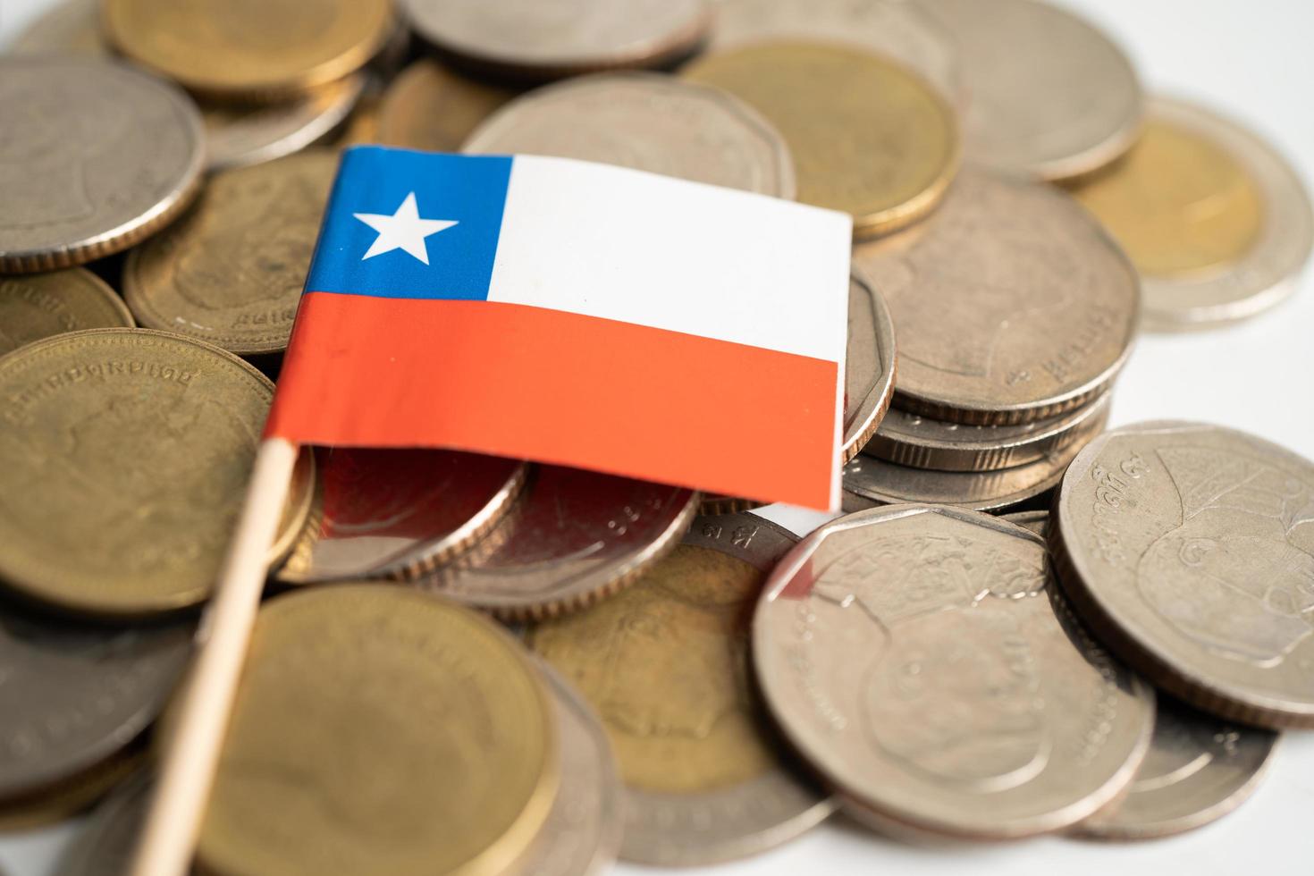 pila de monedas de dinero con la bandera de chile, concepto de banca financiera. foto