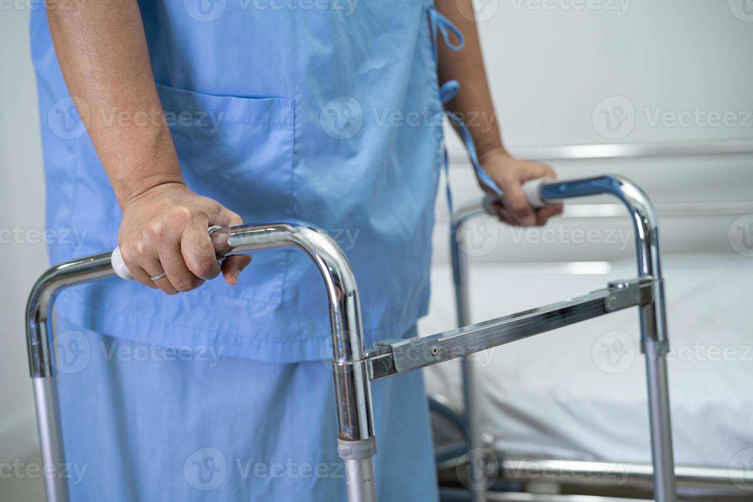 Asian lady woman patient walk with walker at nursing hospital ward, healthy strong medical concept photo