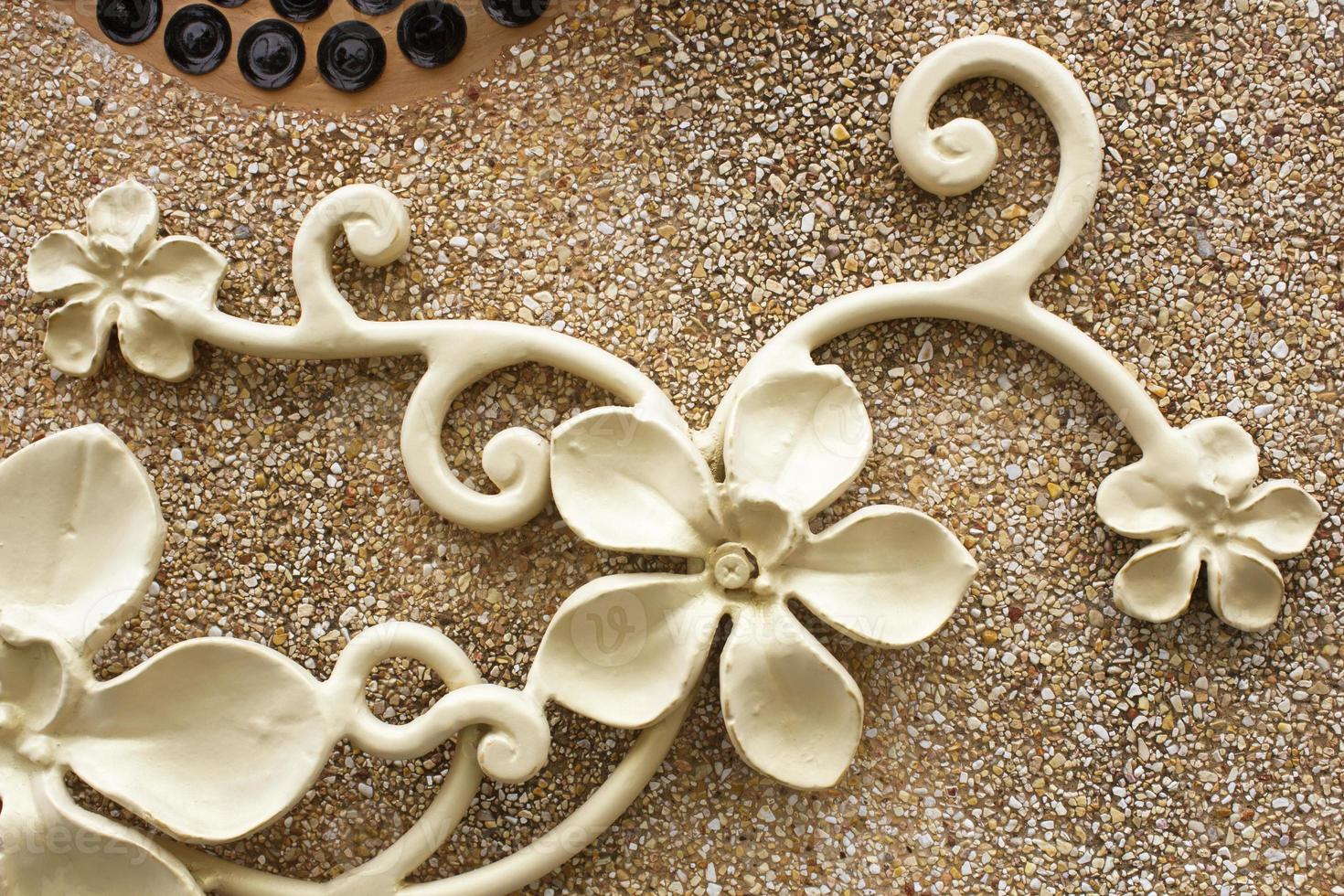 Wrought iron flower on the terrazzo floor. photo