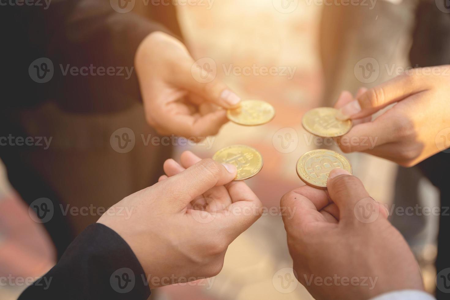 hand of a businessman holding bitcoins and solve puzzles together A business team assembles a bitcoin puzzle, a business group that wants to collect puzzle pieces. photo