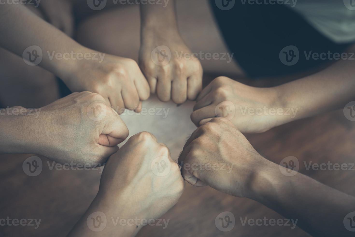 Close the perspective of young businessmen put their hands together, piles of hands, unity and teamwork concepts. photo