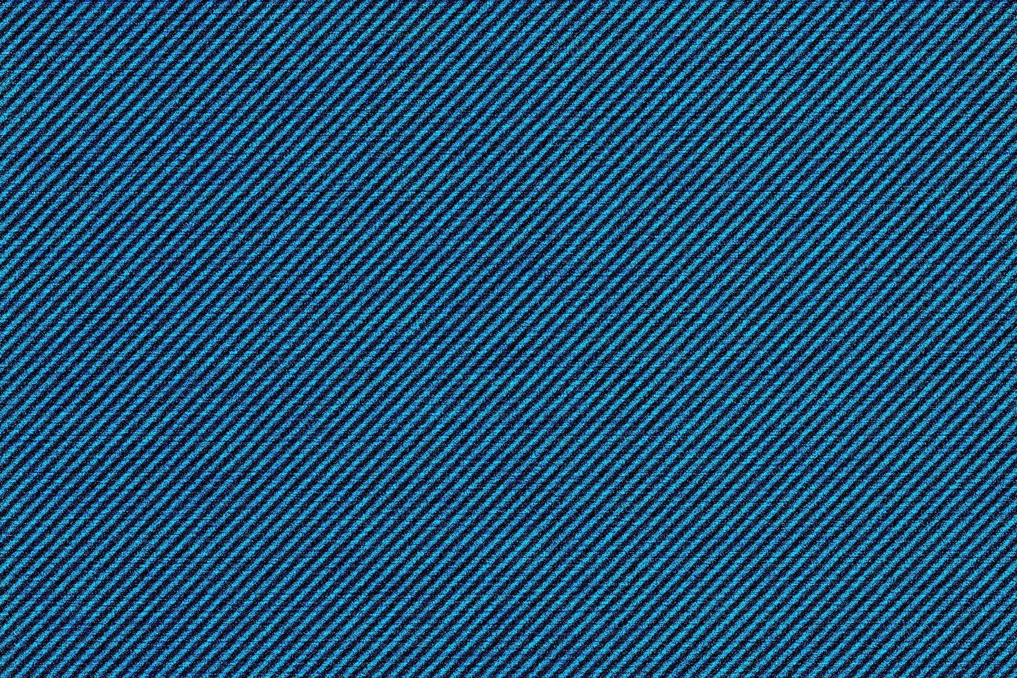 fondo de textura de tela de mezclilla azul oscuro, la tela de algodón fuerte que se usa especialmente para hacer jeans. foto