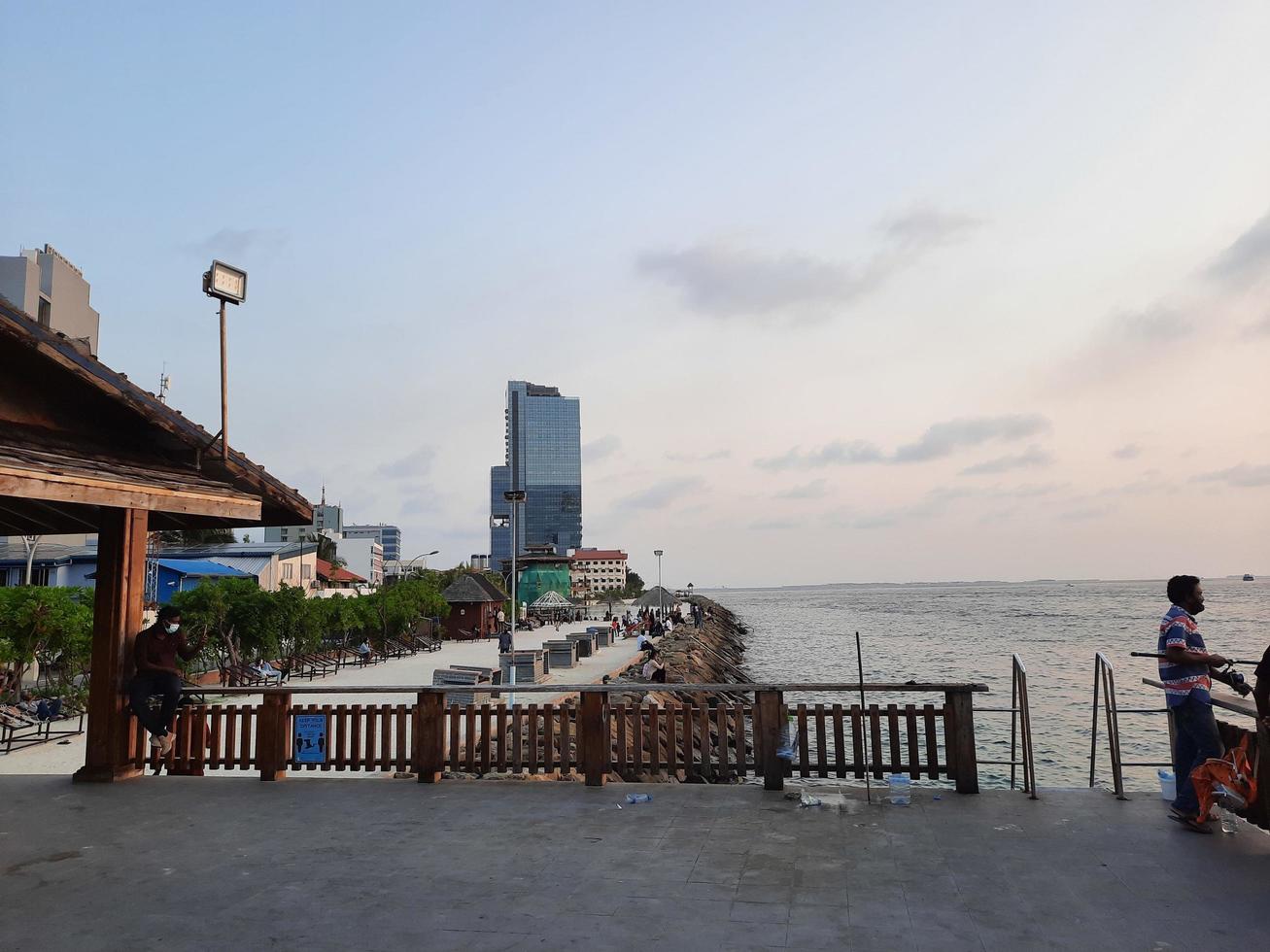 Male, Maldives, April 2021 - Beautiful view of the  sea from the beach in Male, the capital of Maldives. In the evening, large numbers of people come to see the sea from the coast of Male. photo