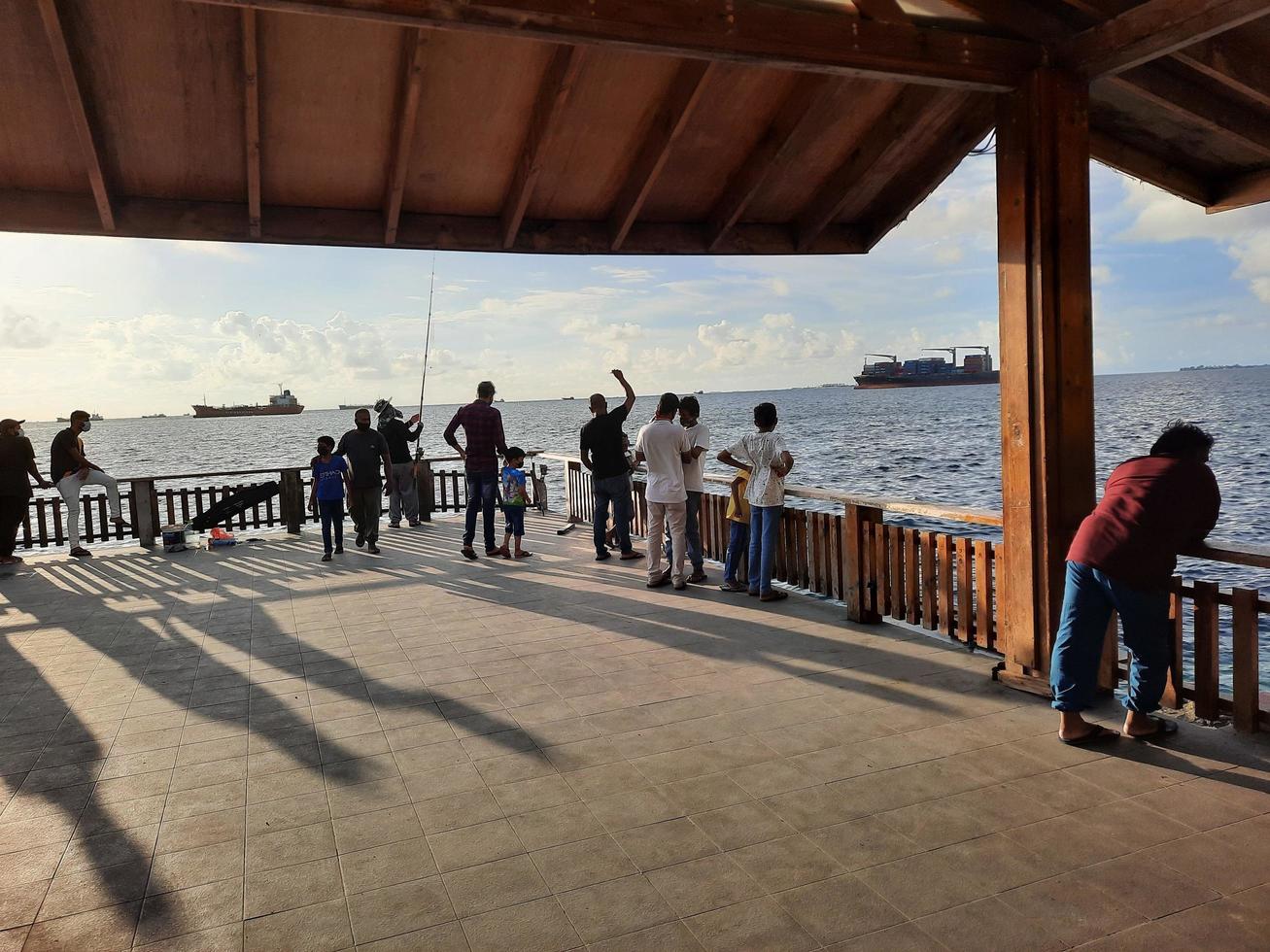 Male, Maldives, April 2021 - Beautiful view of the  sea from the beach in Male, the capital of Maldives. In the evening, large numbers of people come to see the sea from the coast of Male. photo