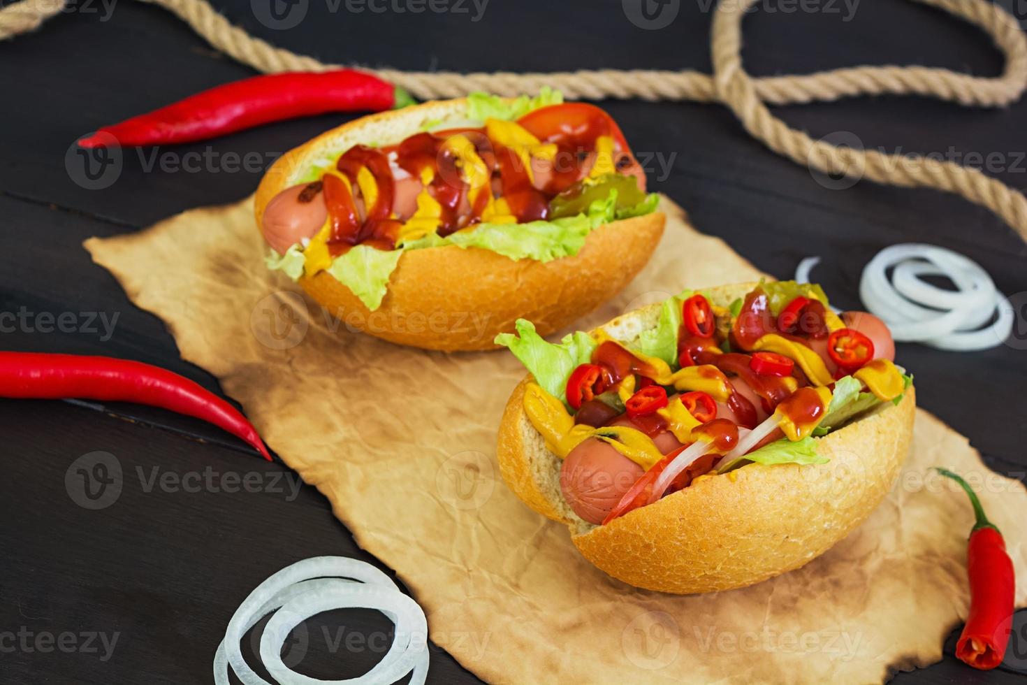 Delicious homemade hot dog on dark background photo