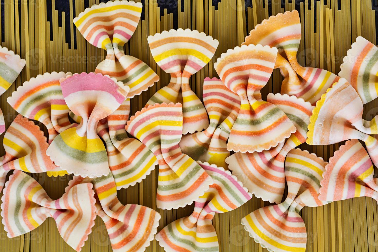 Mixed colorful farfalle pasta. Flat lay. Top view. photo