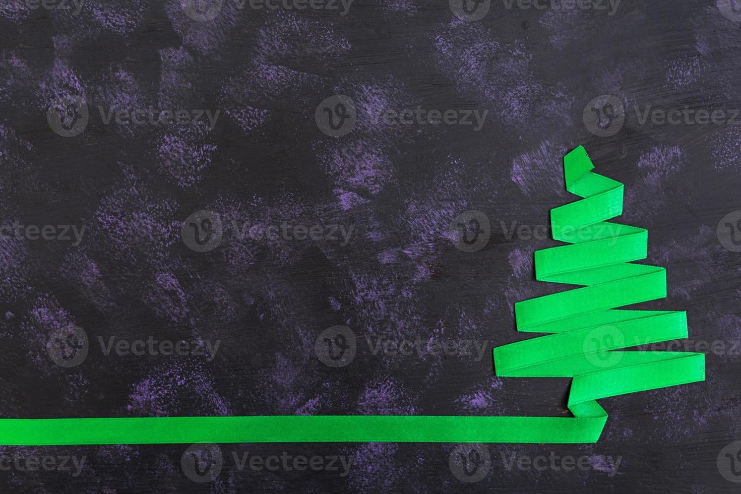 Christmas tree made of ribbon on dark background. photo