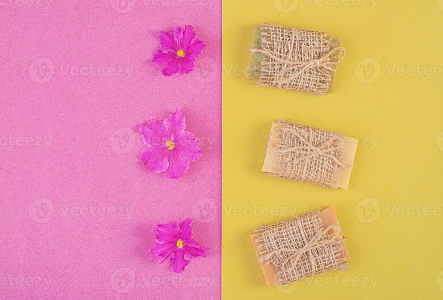 Hand made soap bars on pink-yellow background. Top view. Mockup for design photo