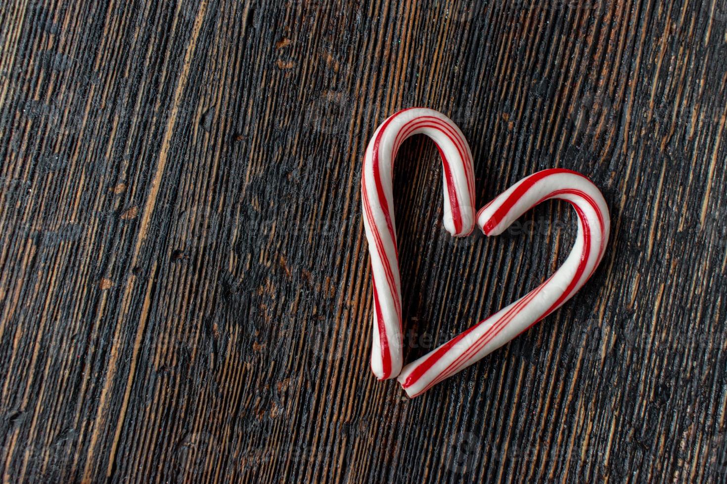 candy cane heart with copy space on rustic wood table flat lay photo